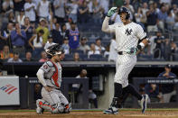 New York Yankees' Aaron Judge celebrates his home run as he crosses home plate past Houston Astros catcher Yainer Diaz during the third inning of a baseball game Wednesday, May 8, 2024, in New York. (AP Photo/Adam Hunger)