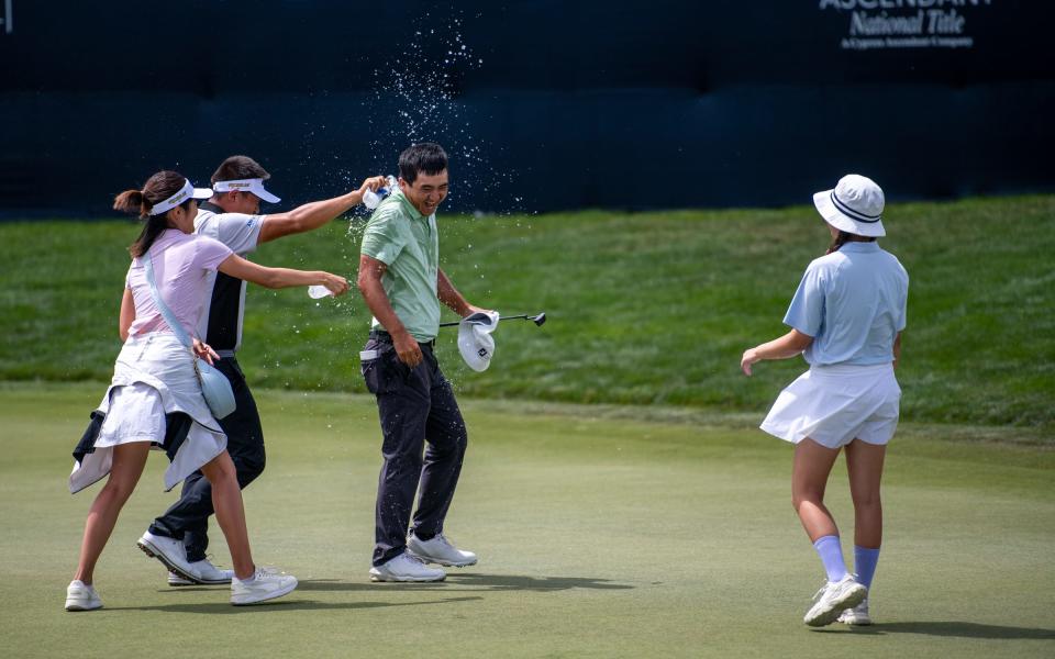 Professional golfer Zecheng "Marty" Dou has water dumped on him by friends after clinching his victory on the 18th green in the final round of The Ascendant at TPC Colorado in Berthoud, Colo. on Sunday, July 3, 2022.