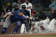 Atlanta Braves' Eddie Rosario (8) beats a tag by Los Angeles Dodgers catcher Will Smith, left, as he scores on a Marcell Ozuna double in the eighth inning of a baseball game, Monday, May 22, 2023, in Atlanta. (AP Photo/John Bazemore)