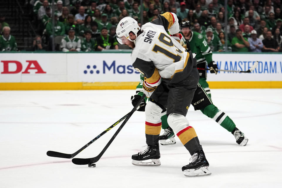 Vegas Golden Knights right wing Reilly Smith (19) lines up a shot as Dallas Stars' Miro Heiskanen, rear, defends in the second period of Game 6 of the NHL hockey Stanley Cup Western Conference finals, Monday, May 29, 2023, in Dallas. (AP Photo/Tony Gutierrez)