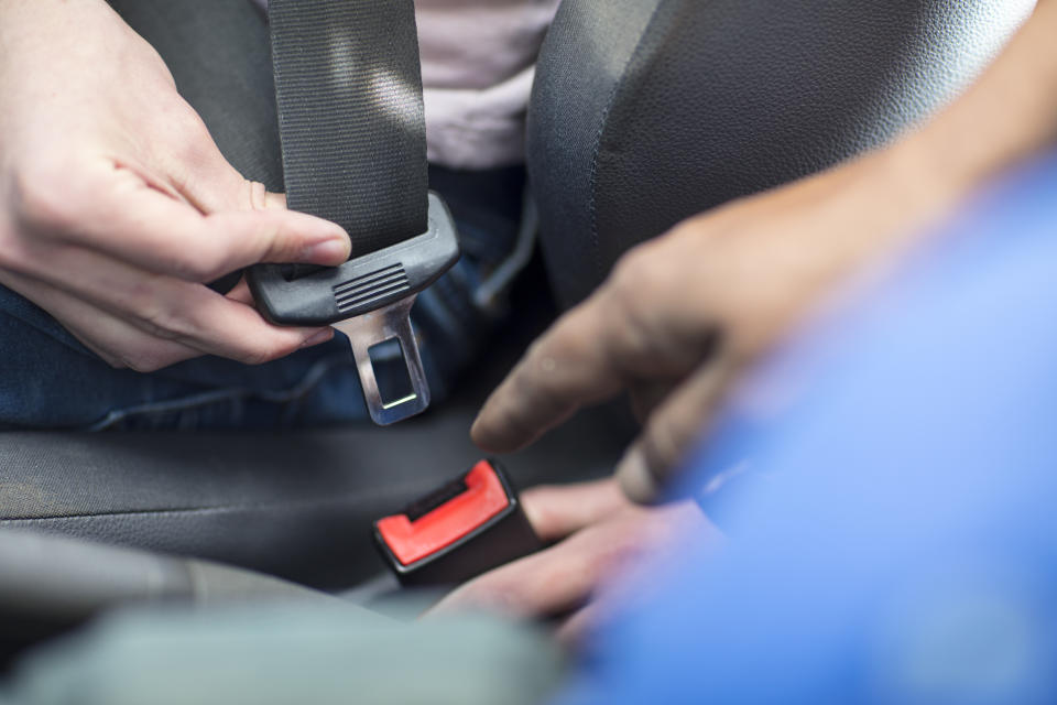 Picture of someone putting their seatbelt on. Teens in rural or remote communities are less likely to wear seatbelts compared to kids in metropolitan areas.