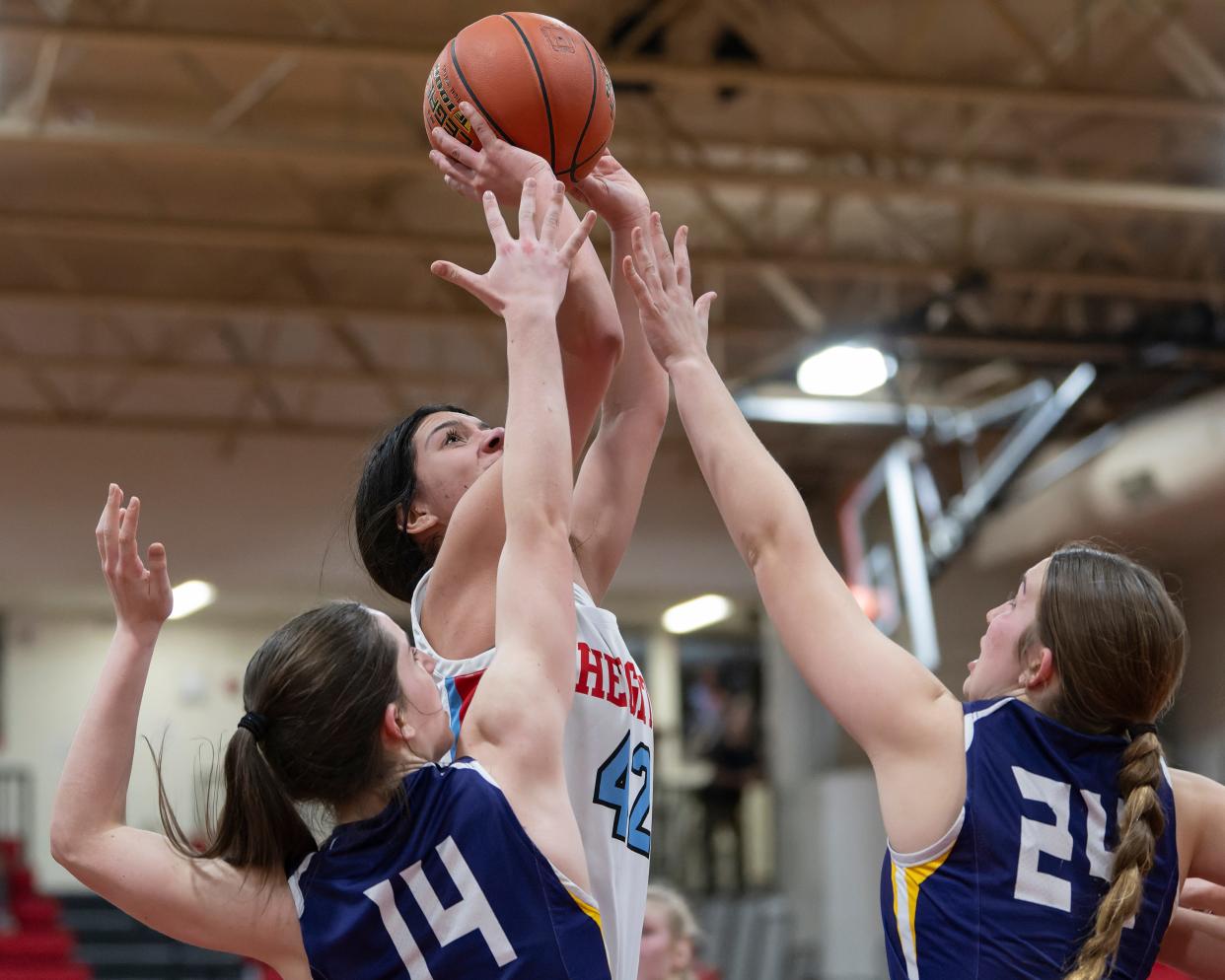 Shawnee Height's Reianna Vega (42) shoots the ball against Piper’s forward Jade Arwine (14) and Sage Grann (24) February. 28, 2024 at Shawnee Heights High School.