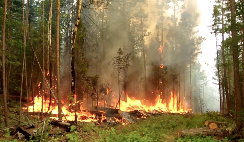 This photo taken from a footage provided by the RU-RTR Russian television, shows a forest fire in the republic of Sakha Republic, eastern Russia, on Wednesday, July 15, 2020. The region's capital Yakutsk has been covered in thick smog from the nearby fires, threatening residents with respiratory and cardiovascular problems.An estimated 106 wildfires are currently raging in the republic. (RU-RTR Russian Television via AP)