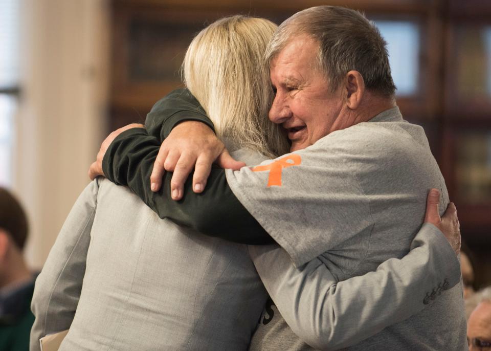 Leonard Manley, father of Dana Manley Rhoden, hugs Special Prosecutor Angie Canepa before the arraignment of Angela Wagner, in 2018.