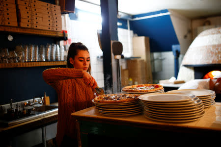 Pizza is prepared inside the Apollo Pizzeria, in London, Britain, January 22, 2019. REUTERS/Henry Nicholls