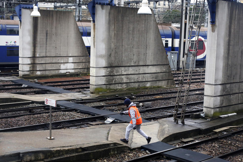 A worker walks on a platform at the Gare Montparnasse railway station, in Paris, Wednesday, Dec. 11, 2019. After hundreds of thousands of angry protesters marched through French cities, the prime minister is expected to unveil proposals that might calm tensions on the 7th straight day of a crippling transport strike. (AP Photo/Thibault Camus)