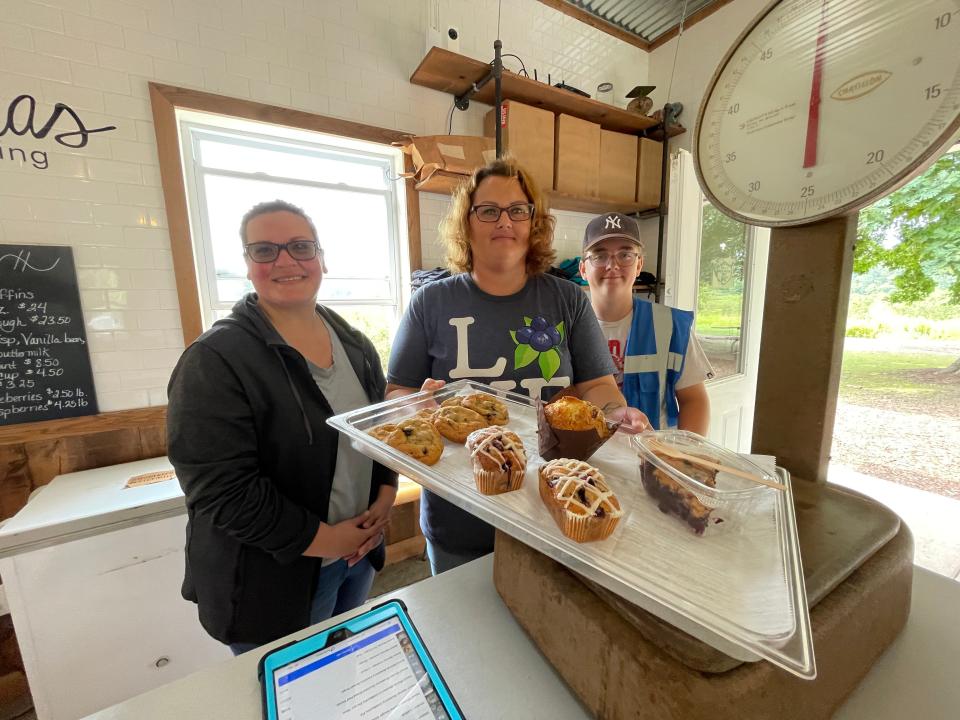 From left, Cassie Tarnowski, Cathy Brennan and Rylan Brennan show blueberry baked goods for sale at Hazen's Farm.