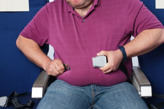 Overweight man in an airplane