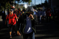 People walk in a caravan of migrants departing from El Salvador en route to the United States, in San Salvador, El Salvador, November 18, 2018. REUTERS/Jose Cabezas