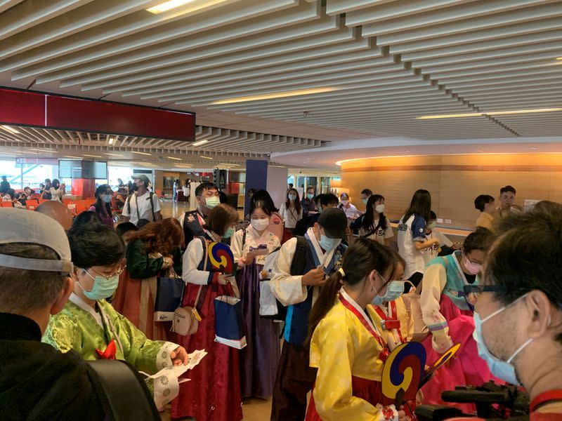 Passengers are seen before boarding a Tigerair Taiwan flight that will circle over South Korea's Jeju Island and then return to Taoyuan