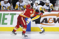 Pittsburgh Penguins' Kris Letang, right, runs into Calgary Flames' Blake Coleman during the second period of an NHL hockey game, Monday, Nov. 29, 2021 in Calgary, Alberta. (Larry MacDougal/The Canadian Press via AP)