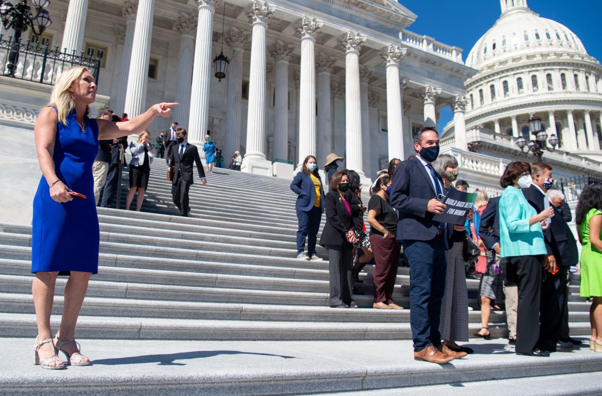 Representative Marjorie Taylor Greene (L), Republican of Georgia, yells at House Democratic members of Congress as the House Democratic Women's Caucus prepares to hold a press conference promoting the Build Back Better agenda on the steps of the U.S. Capitol in Washington, DC, on Friday, September 24, 2021.