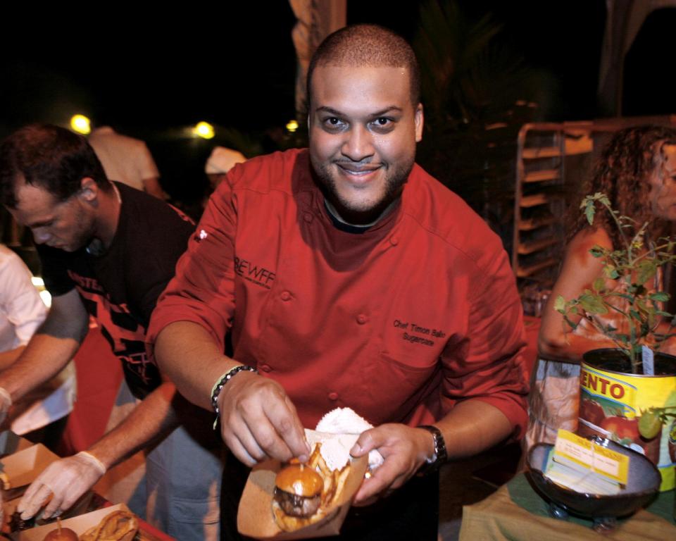 Timon Balloo of Miami's Sugarcane Raw Bar Grill poses while competing in the Burger Bash at the Food Network South Beach Wine & Food Festival in Miami Beach, Fla., Friday, Feb. 24, 2012.(AP photo/Jeffrey M. Boan)