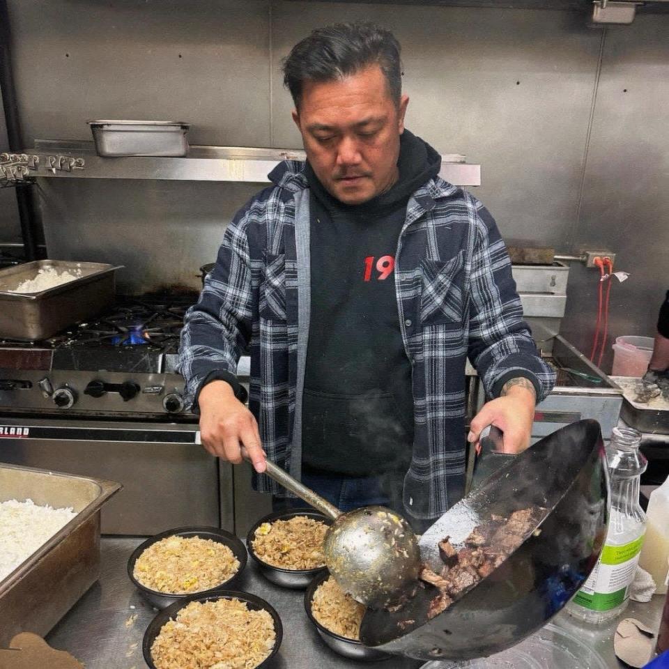 Alex Hanesakda prepares brisket fried rice for a pop-up dinner at Amorphic Beer on Feb. 17.