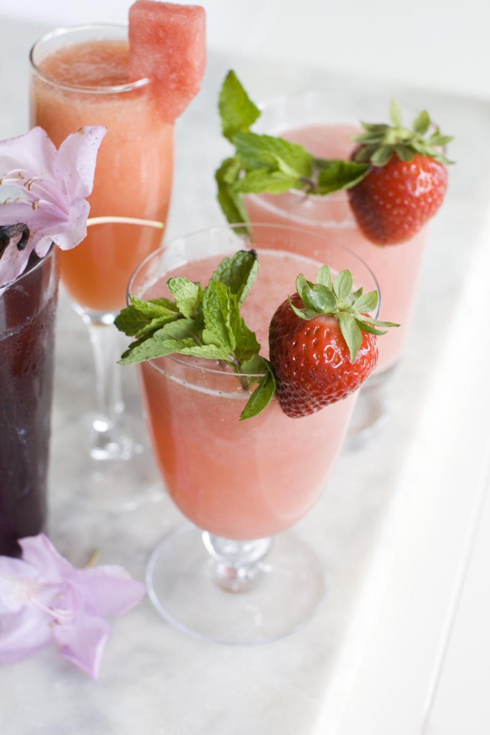 In this image taken on June 3, 2013, from top left, a watermelon Bellini and rose tinted glasses wine coolers are shown in Concord, N.H. (AP Photo/Matthew Mead)