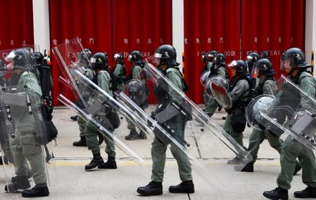 Riot police officers patrol Wong Tai Sin district during an anti-government protests in Hong Kong