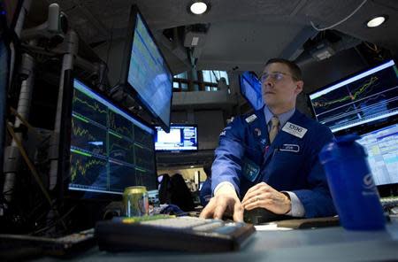 A trader works on the floor of the New York Stock Exchange in New York, December 27, 2013. REUTERS/Carlo Allegri