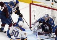 St. Louis Blues center Robert Thomas, back left, puts a shot past Colorado Avalanche goaltender Darcy Kuemper, right, for the tying score as defenseman Cale Makar defends late in the third period of Game 5 of an NHL hockey Stanley Cup second-round playoff series Wednesday, May 25, 2022, in Denver. (AP Photo/David Zalubowski)