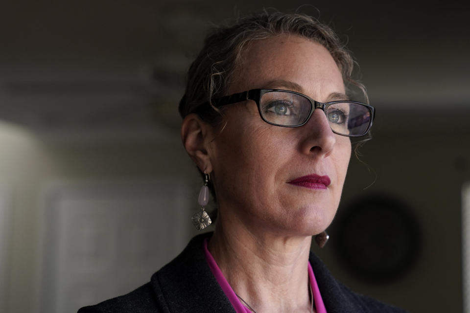 Susanna Schmitt Williams poses at her home in Chapel Hill, N.C., Thursday, Feb. 25, 2021. Williams, the former chief of the Carrboro Fire Department, considered suicide after enduring harassment in her department despite becoming chief. Advocates for female firefighters say their struggles are part of a larger trend, as evidenced by recent gender discrimination lawsuits against fire departments in Illinois, Virginia, and Texas. (AP Photo/Gerry Broome)