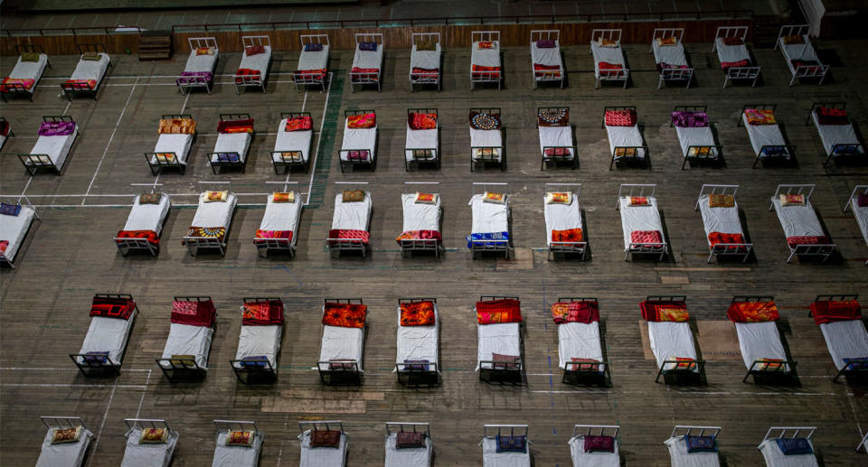 Beds lie inside an indoor stadium converted into COVID-19 treatment center for emergencies in the wake of the spike in the numbers of positive coronavirus cases in Srinagar, Indian controlled Kashmir, Wednesday, April 28, 2021. India, a