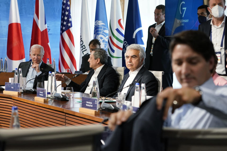 President Joe Biden, left, talks with Italy's Prime Minister Mario Draghi, second from left, as they and Executive Director of the International Energy Agency Fatih Birol, second from right, wait for the start of a lunch with the Group of Seven leaders at the Schloss Elmau hotel in Elmau, Germany, Monday, June 27, 2022, during the annual G7 summit. Joining the Group of Seven are guest country leaders and heads of international organizations. Canada's Prime Minister Justin Trudeau hangs his coat on the back of his chair at right. (AP Photo/Susan Walsh, Pool)
