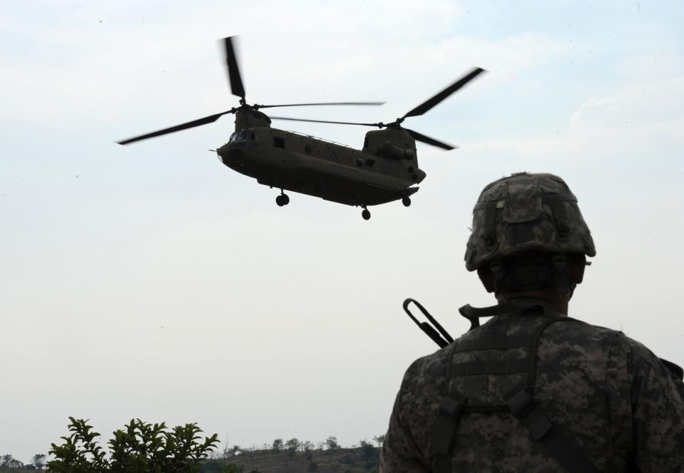 A U.S. Army soldier from 2nd Stryker Brigade Combat of the 5th Infantry Division based in Hawaii watches while a CH-47 Chinook helicopter prepares to land during an air assault exercise with their Philippine counterparts inside the military training camp of Fort Magsaysay in Nueva Ecija province north of Manila, in 2015 as the Philippines voiced alarm about Chinese "aggressiveness" in disputed regional waters.