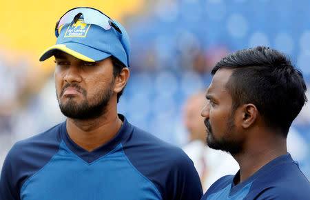 Cricket - Sri Lanka v India - Third Test Match - Pallekele, Sri Lanka - August 14, 2017 - Sri Lanka's captain Dinesh Chandimal reacts next to his teammate Malinda Pushpakumara after losing the final test match and the test series against India. REUTERS/Dinuka Liyanawatte