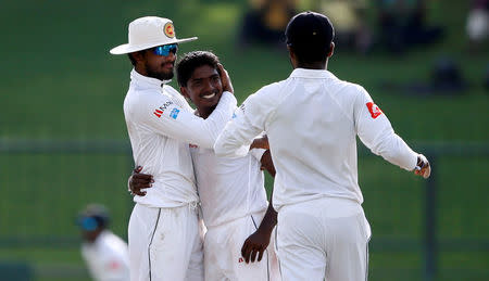 Cricket - Sri Lanka v India - Third Test Match - Pallekele, Sri Lanka - August 12, 2017 - Sri Lanka's Lakshan Sandakan celebrates with captain Dinesh Chandimal after taking the wicket of India's captain Virat Kohli (not pictured). REUTERS/Dinuka Liyanawatte