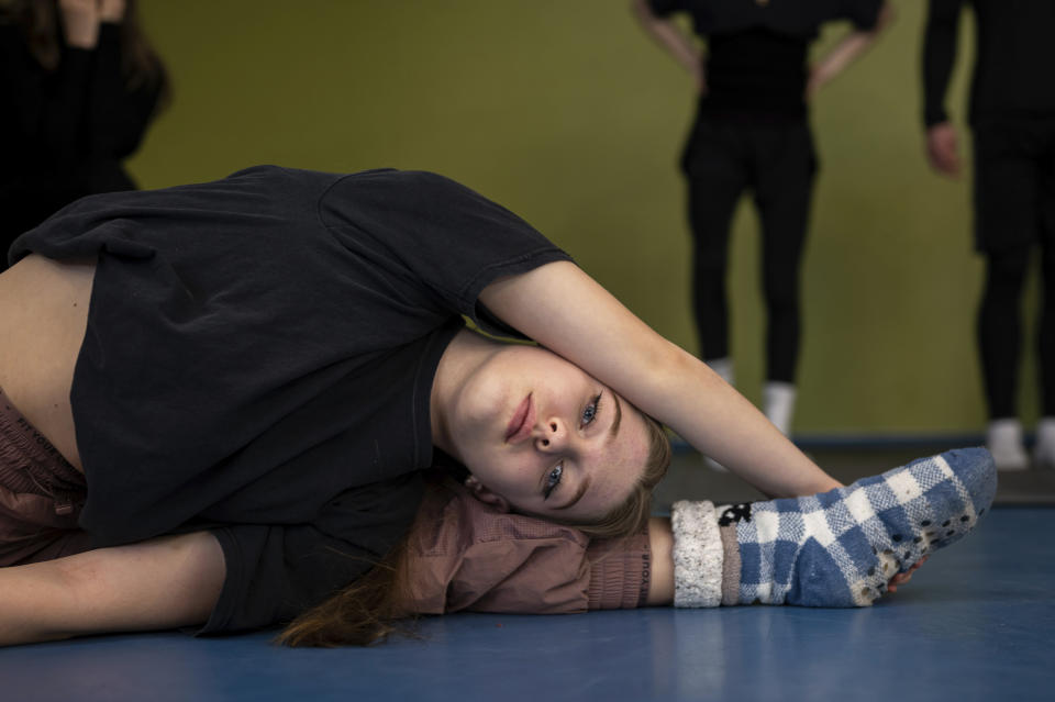 Ukrainian refugee circus student Mariia Lysytska stretching in a training room in Budapest, Hungary, Monday, Feb. 13, 2023. More than 100 Ukrainian refugee circus students, between the ages of 5 and 20, found a home with the Capital Circus of Budapest after escaping the embattled cities of Kharkiv and Kyiv amid Russian bombings. (AP Photo/Denes Erdos)
