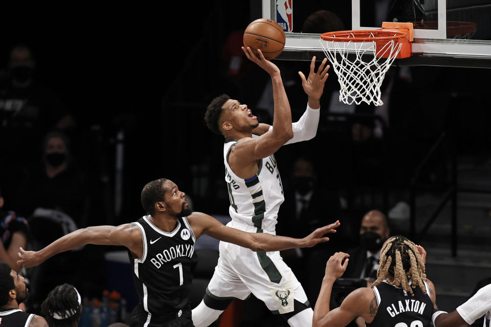 Milwaukee Bucks forward Giannis Antetokounmpo (34) drives to the basket past Brooklyn Nets forward Kevin Durant (7) during Game 1. (AP Photo/Adam Hunger)