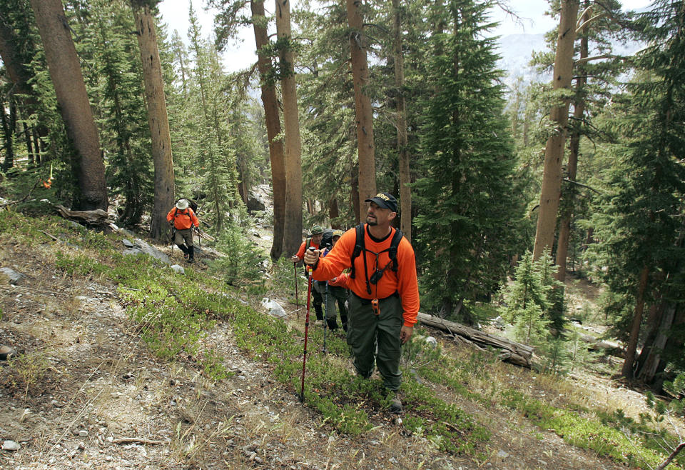 FILE - John Amoroso of the Kern County Search and Rescue, climbs up to the crash site of adventurer Steve Fossett near Mammoth Lakes, Calif., on Oct. 2, 2008. The massive hunt for the Titan submersible that imploded deep in the North Atlantic has refocused attention on whether wealthy risktakers should pay for emergency search and rescue efforts, a conundrum that comes as the world's wealthiest seek out singular adventures atop peaks, under the ocean and in space. (AP Photo/Rich Pedroncelli, Pool)