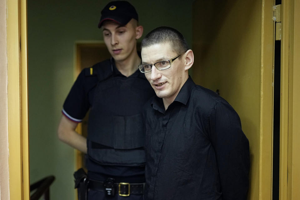U.S. citizen Robert Woodland is escorted to a court room prior to a court session on drug-related charges in Moscow, Russia, Thursday, July 4, 2024. Woodland was arrested on drug charges in January and faces up to 20 years in prison if convicted. Robert Woodland, a Russia-born U.S. citizen, was convicted of drug-related charges by a Moscow court and sentenced to 12 1/2 years in prison on Thursday. (AP Photo/Alexander Zemlianichenko)