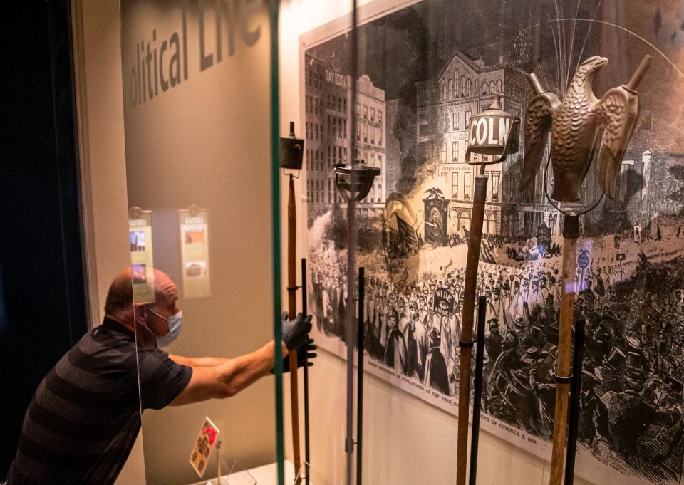 Mike Casey, exhibits designer at the Abraham Lincoln Presidential Library and Museum, replaces artifacts in the Political Life exhibit after they were in storage and the vault at the Abraham Lincoln Presidential Museum as workers prepare to reopen the museum during the COVID-19 pandemic, Friday, June 26, 2020, in Springfield, Ill.