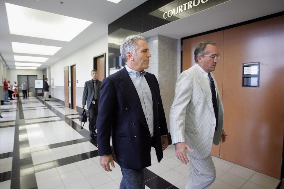 Jeffrey Epstein enters the courtroom at the Palm Beach County courthosue with his attorney Guy Lewis on June 30, 2008, when Epstein pleaded guilty to two felony prostitution-related charges. He was given 18 months in jail, not prison, and was required to register as a sex offender.