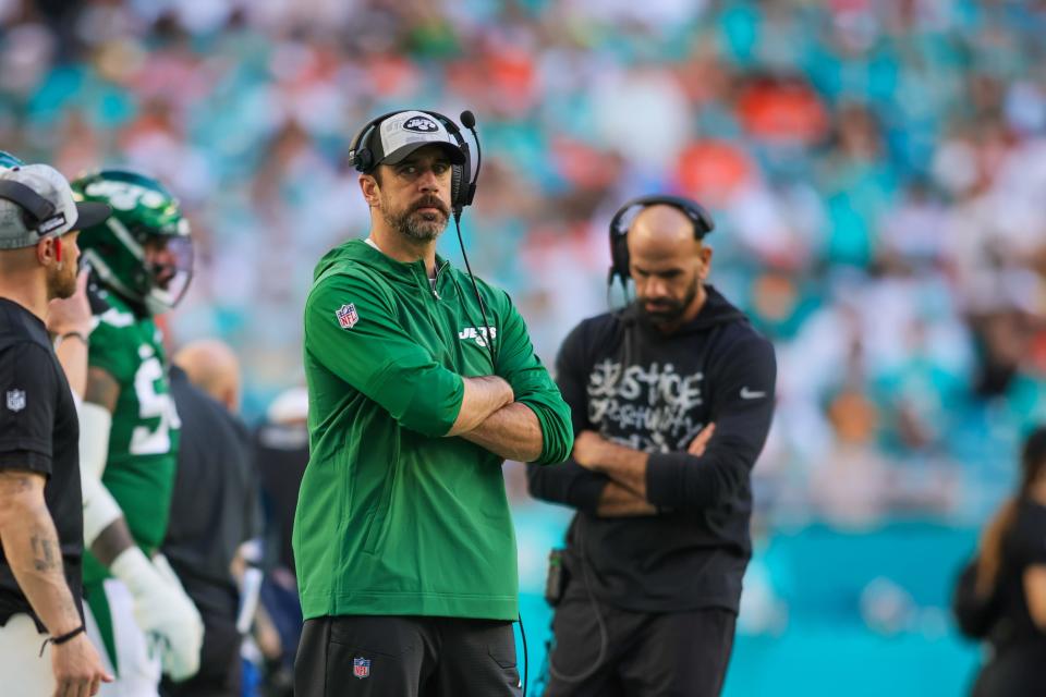 Aaron Rodgers looks on from the sideline during the New York Jets' 30-0 loss against the Miami Dolphins at Hard Rock Stadium on Dec. 17, 2023.