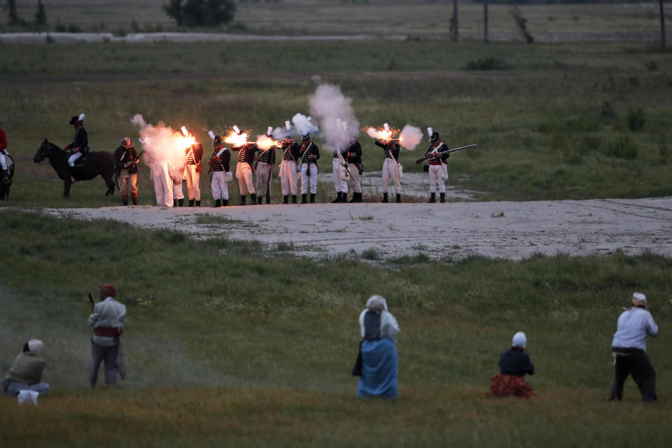 Slaves, forefront, advance towards soldiers at the start of a skirmish during a performance artwork reenacting the largest slave rebellion in U.S. history, in LaPlace, La., Friday, Nov. 8, 2019. The reenactment was conceived by Dread Scott, an artist who often tackles issues of racial oppression and injustice. Scott says that those who took part in the rebellion were "heroic" and that the rebellion is something that people should know about and be inspired by. (AP Photo/Gerald Herbert)