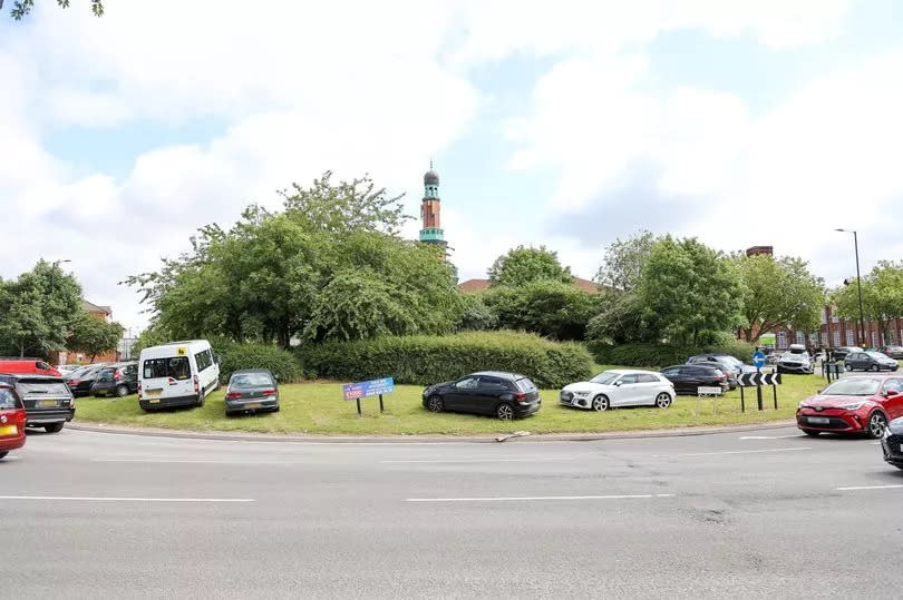 Cars parked on Poets Corner roundabout at Small Heath. -Credit:SWNS