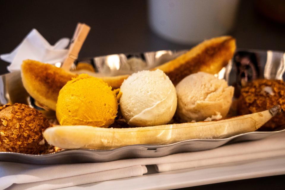 From left: Scoops of banana saffron, pistachio, and foie gras ice cream are seen atop the $100 banana split at Oak Park on Wednesday, Dec. 20, 2023, in Des Moines.