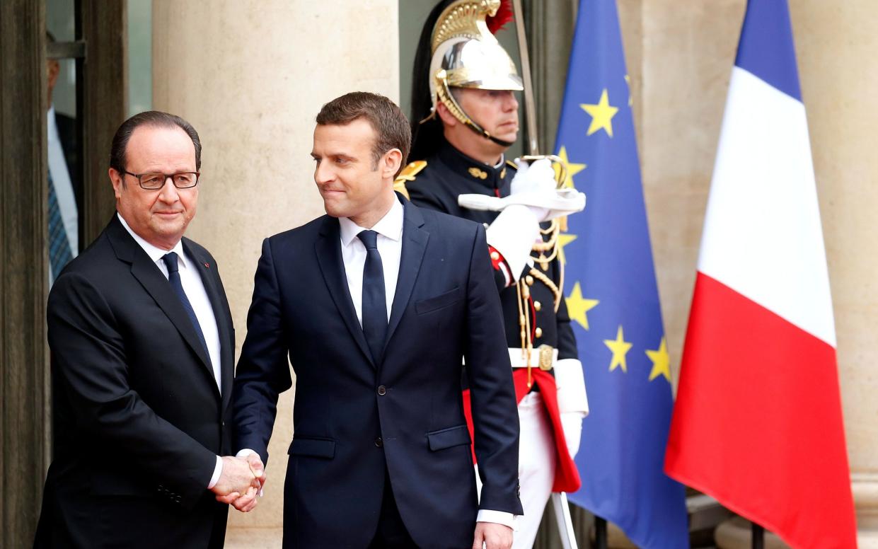 Outgoing French President Francois Hollande greets President-elect Emmanuel Macron at the Elysée in 2017 - Reuters