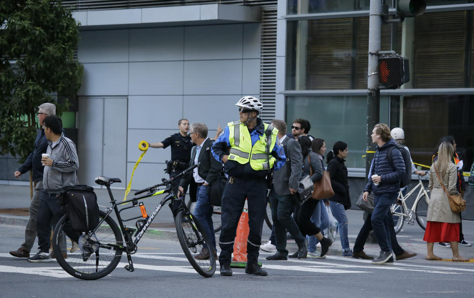 People are directed around the Salesforce Transit Center following its closure Tuesday, Sept. 25, 2018, in San Francisco. San Francisco officials shut down the city's celebrated new $2.2 billion transit terminal Tuesday after discovering a crack in a support beam under the center's public roof garden. Coined the "Grand Central of the West," the Salesforce Transit Center opened in August near the heart of downtown after nearly a decade of construction. It was expected to accommodate 100,000 passengers each weekday, and up to 45 million people a year. (AP Photo/Eric Risberg)