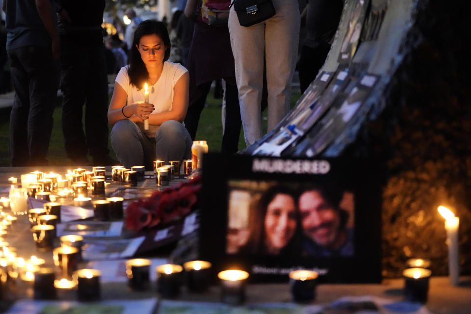 People light candles during the 'Jewish Community Vigil' for Israel in London, Monday, Oct. 9, 2023 two days after Hamas fighters launched an unprecedented, multi-front attack on Israel which killed more than 700 people. The militants blew through a fortified border fence and gunned down civilians and soldiers in Israeli communities along the Gaza frontier during a Jewish holiday. (AP Photo/Kin Cheung)