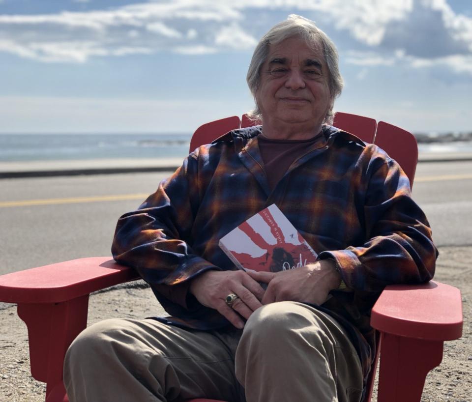 Author Colin Sargent is seen here with his new novel, "Red Hands," as he sits in front of his home on Beach Avenue in Kennebunk, Maine, on Thursday, Oct. 12, 2023.
