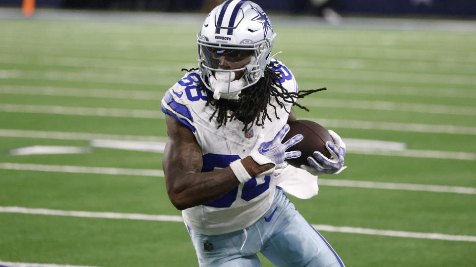 Dallas Cowboys wide receiver CeeDee Lamb looks for running room after catching a pass in the second half of an NFL football game against the Seattle Seahawks in Arlington, Texas, Thursday, Nov. 30, 2023. (AP Photo/Michael Ainsworth)