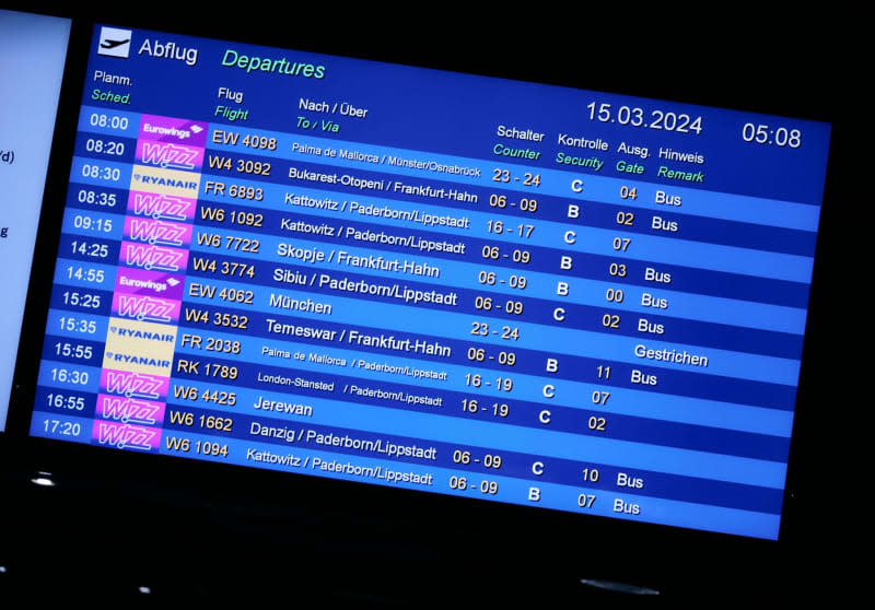 The display board at Dortmund Airport shows the day's flights, most of which will be replaced by buses during a strike by security staff. The trade union Verdi has called for further warning strikes by aviation security staff at several German airports. Bernd Thissen/dpa