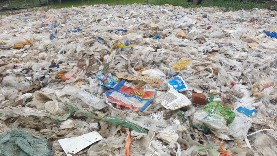Mound of plastic waste in Ward 27 of Shwe Pyi Thar township in Yangon. Plastic packaging from foreign brands, not sold in Myanmar, is visible (Supplied to The Independent)