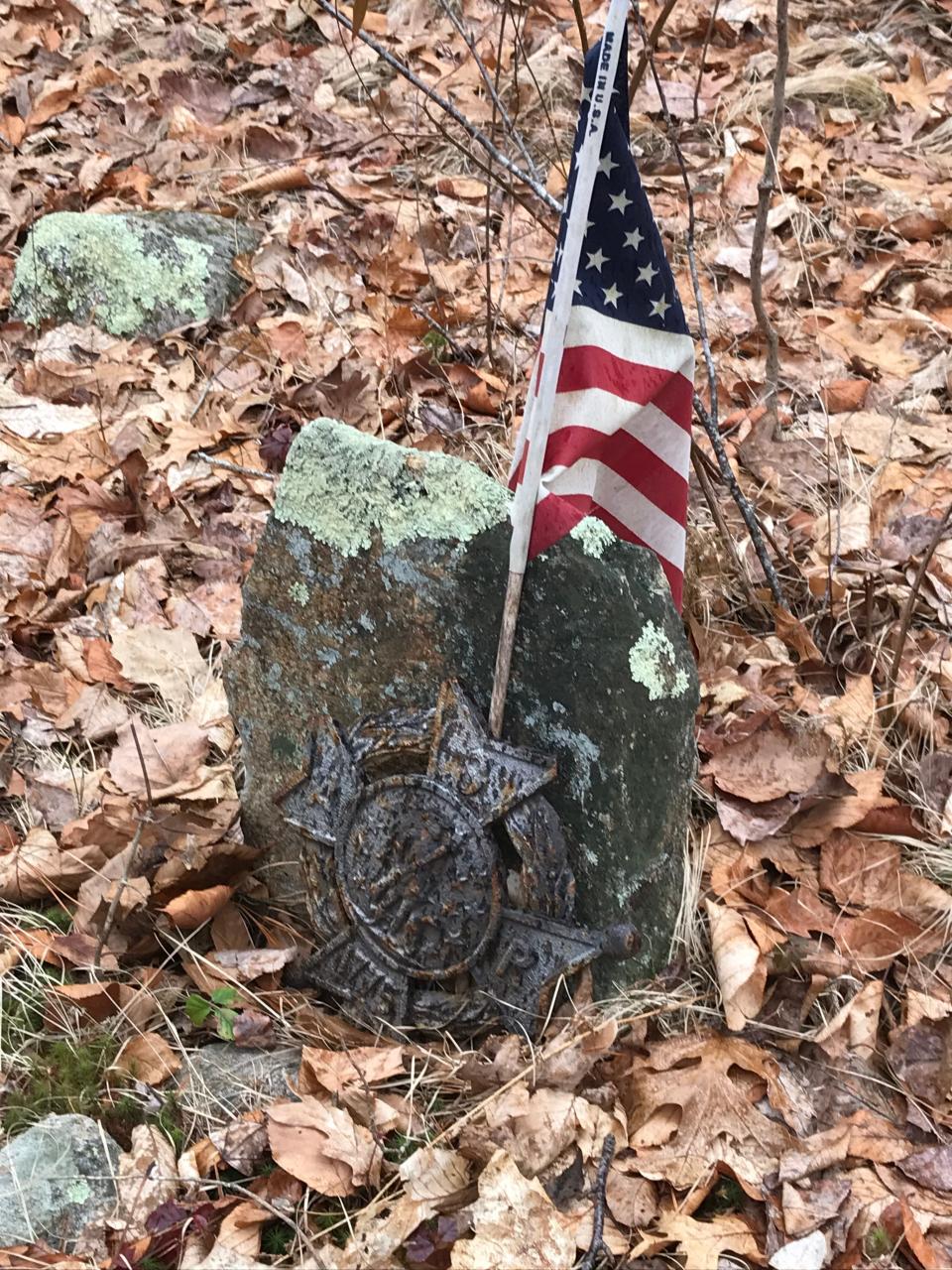 A marker, stamped 1775, is in front of a small stone in the Perkins family cemetery.