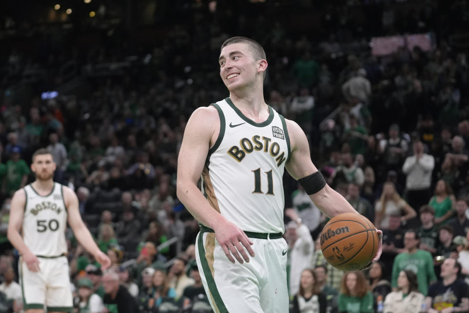 Boston Celtics guard Payton Pritchard (11) smiles as the Celtics lead the Washington Wizards in the second half of an NBA basketball game, Sunday, April 14, 2024, in Boston. (AP Photo/Steven Senne)