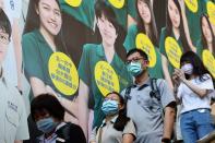 People wear protective face masks while heading in a metro station following the outbreak of coronavirus disease (COVID-19), in Taipei