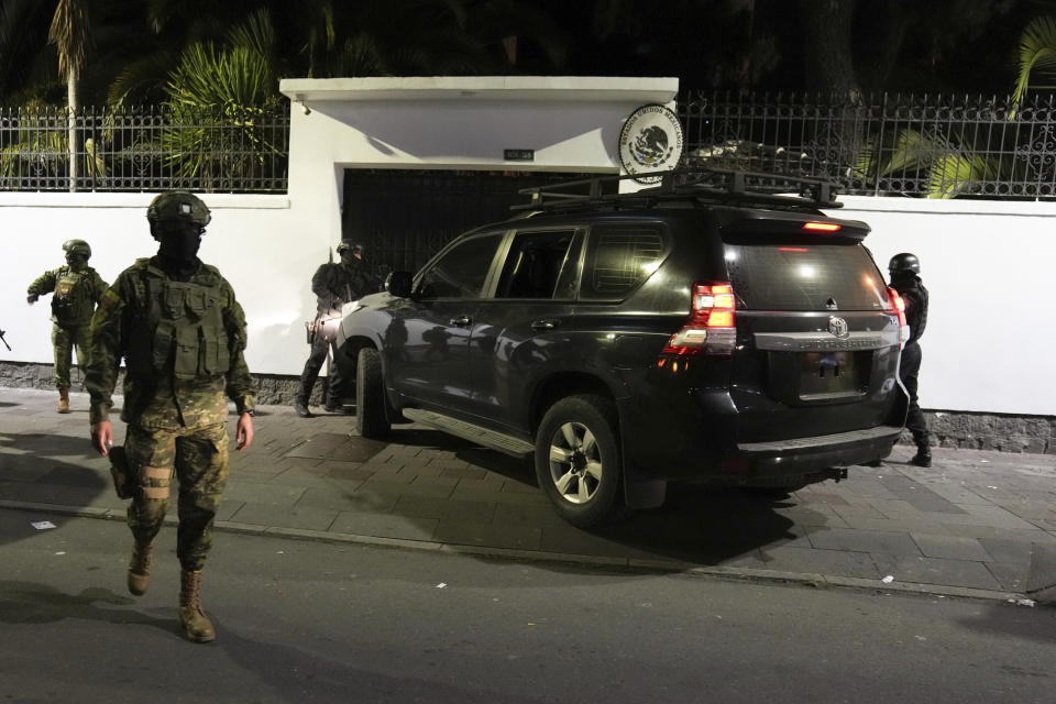 Police attempt to break into the Mexican embassy in Quito, Ecuador, Friday, April 5, 2024, following Mexico's granting of asylum to former Ecuadorian Vice President Jorge Glas, who had sought refuge there. Police later forcibly broke into the embassy through another entrance. (AP Photo/Dolores Ochoa)