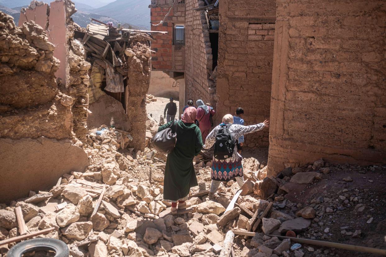 Residents flee their homes after an earthquake in Moulay Ibrahim village (AP)